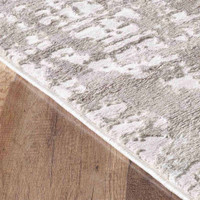 modern abstract lines stone rug closeup edge on a wooden floor