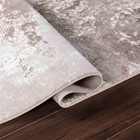 modern abstract sprayed stone rug runner folded on a wooden floor