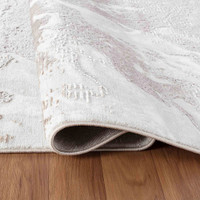 modern abstract water flow stone rug folded on wooden floor