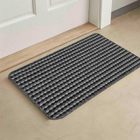 anthracite non-slip dirt trapper mat in front of a door indoors