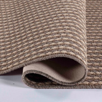 beige non-slip dirt trapper mat folded on white floor