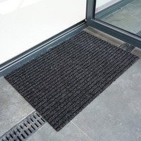 anthracite coir doormat infront of doorway outdoors