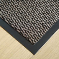 brown non-slip dirt trapper mat closeup corner on wood floor