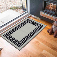 greek key grey doormat in a door way on a wood floor