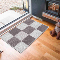 square grey cream doormat in a door way on a wood floor