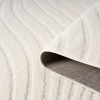 wave cream rug partially rolled