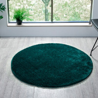 plain emerald rug circle in a living space with a window