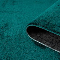 plain emerald rug runner partially rolled