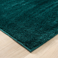 plain emerald rug side view of corner