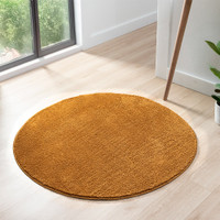 plain gold rug circle in a living space with a window