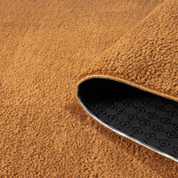 plain gold rug partially rolled