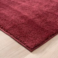 plain red rug side view of corner
