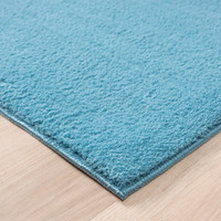 plain teal rug side view of corner