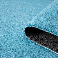 plain teal rug partially rolled
