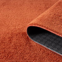 plain terracotta rug runner partially rolled