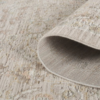 traditional floral beige rug closeup rolled