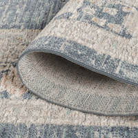 traditional floral navy rug closeup rolled