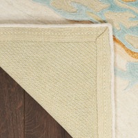 sand blue abstract rug closeup corner folded on dark wood floor
