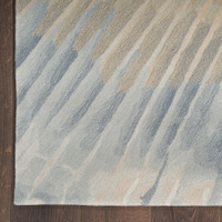 sand abstract rug closeup corner on dark wood floor