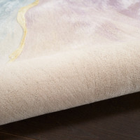 ivory floral rug partially rolled on a dark wood floor