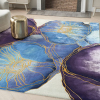 blue gold abstract rug in a living room with furniture