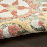 floral sage rose rug closeup rolled on dark wood floor