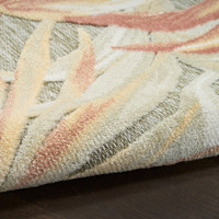 floral sage rose rug closeup rolled on dark wood floor