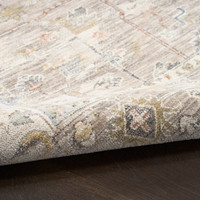 ivory traditional rug closeup rolled on dark wood floor
