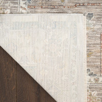 ivory traditional rug closeup corner folded on dark wood floor