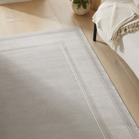 grey beige modern rug closeup living room with white decor