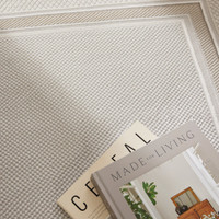 grey beige modern rug closeup with books