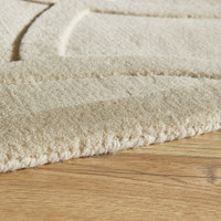 ivory wool rug closeup edge on wood floor