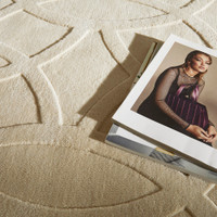 ivory wool rug closeup with books