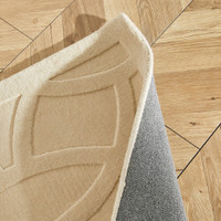 ivory wool rug closeup fold on wood floor