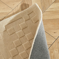 beige wool rug closeup folded
