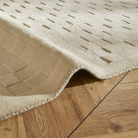 ivory wool rug closeup fold