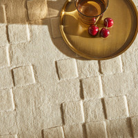 ivory wool rug closeup corner with bowl of fruit