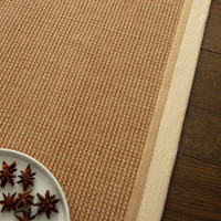 cream linen jute rug closeup with dark wood floor