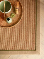 sage linen jute rug closeup corner with plate