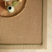 sage linen jute rug closeup corner with plate