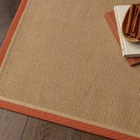 rust linen jute rug on wood floor