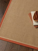 rust linen jute rug on wood floor