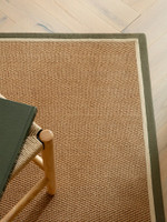 khaki cream jute rug closeup with chair