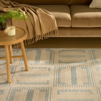 ivory blue geometric rug in a living room
