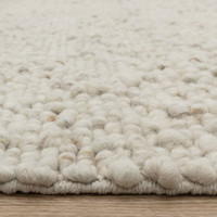 ivory wool rug closeup edge on wood floor