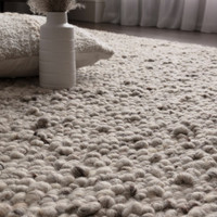 silver wool rug closeup detail with cushion