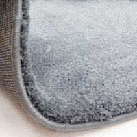 blue plain shaggy rug partial fold on white floor