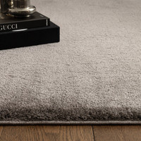 charcoal plain shaggy rug closeup with a plant pot