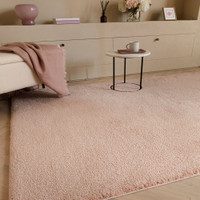 pink plain shaggy rug in a living room with matching decor