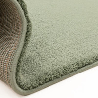 sage plain shaggy rug partial fold on white floor